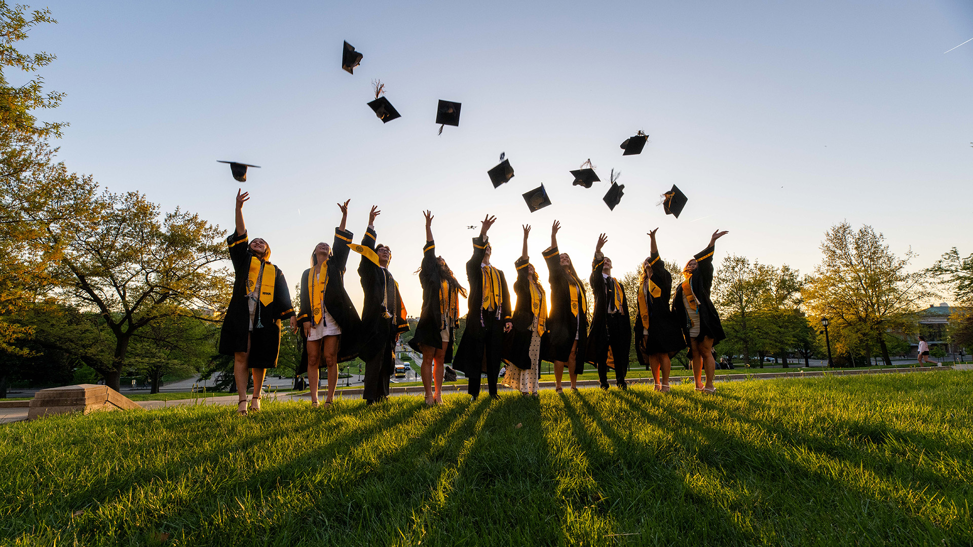 A group of students throwing their caps