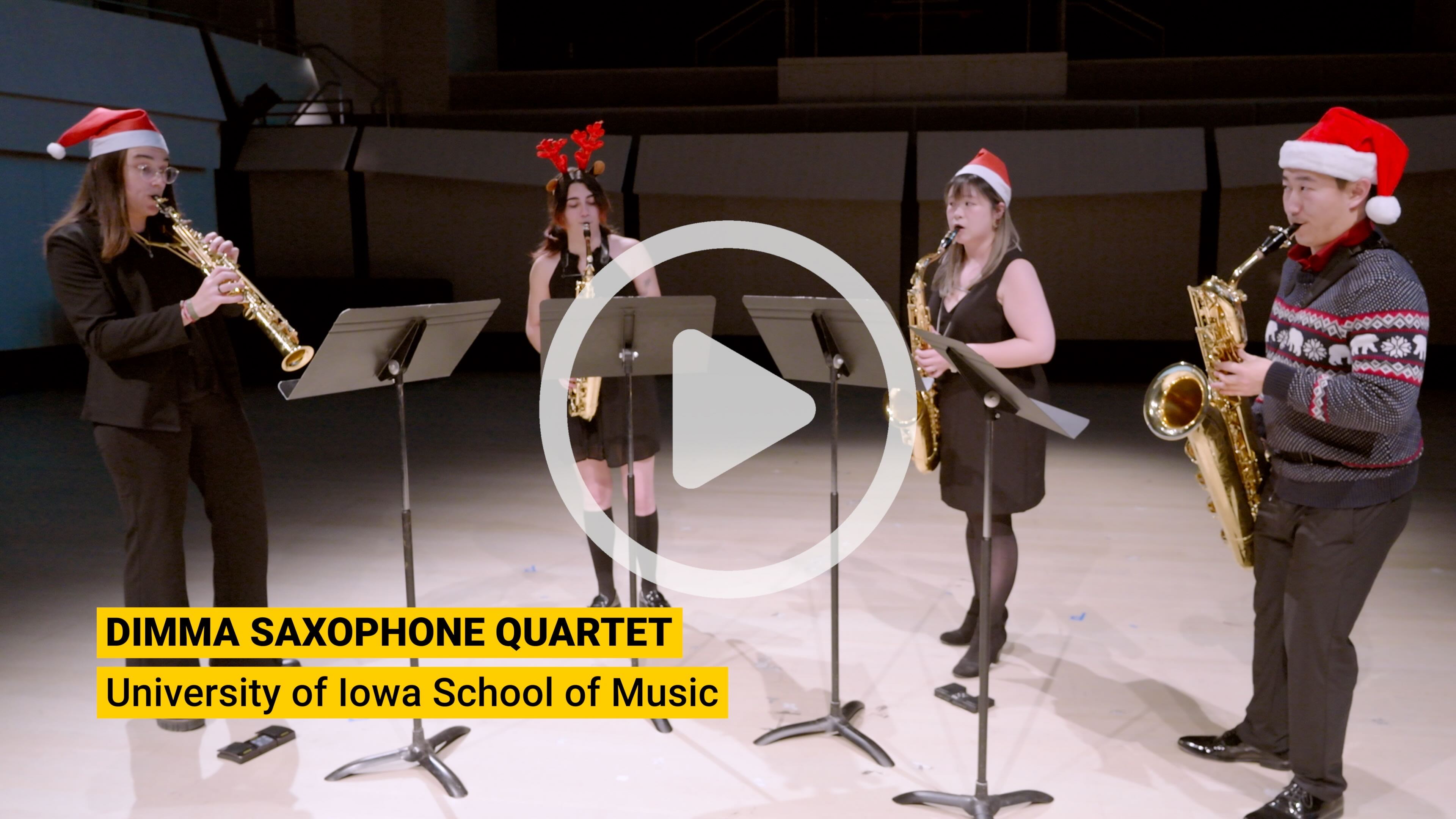 The Dimma Saxophone Quartet, wearing Santa hats, plays 