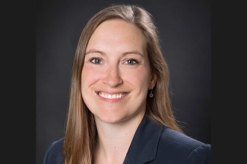 Anna Stanhewicz, smiling. She has long light brown hair parted on the side and blue eyes. 