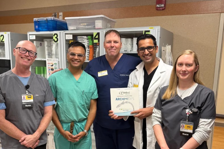 Five members of the team who performed the nation's first ARCHIMEDES procedure. One person is holding a box that says ARCHEMEDES, the name of the device.