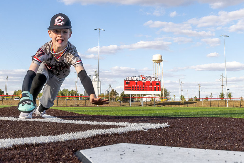 A child in a baseball uniform who was a patient in the burn center