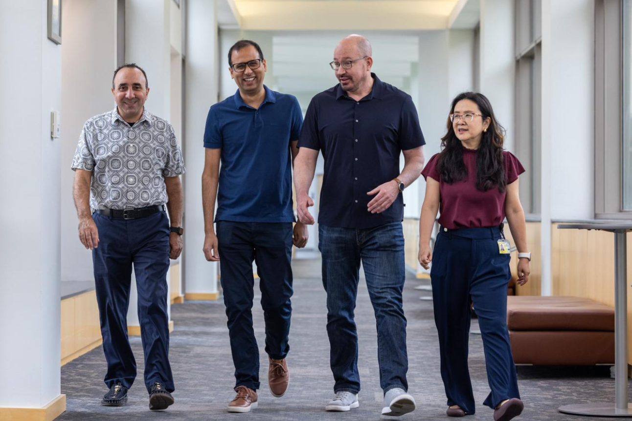 Four researchers walk in a hallway at the UI Fraternal Order of Eagles Diabetes Research Center. From left to right: Kamal Rahmouni, Bhagirath Chaurasia, Eric Taylor, and Ling Yang.
