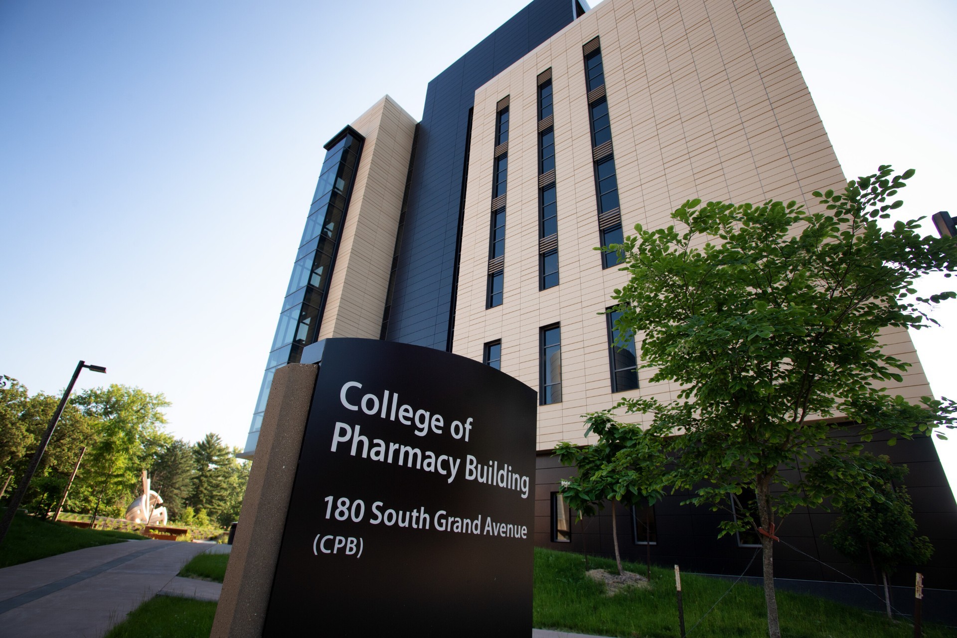 College of Pharmacy building with building sign out front.